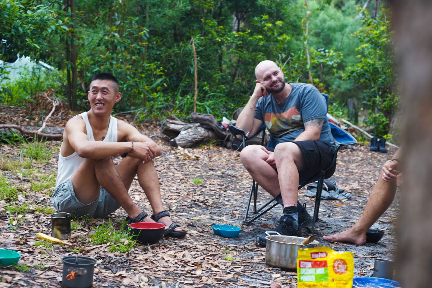 Two men laughing at camp