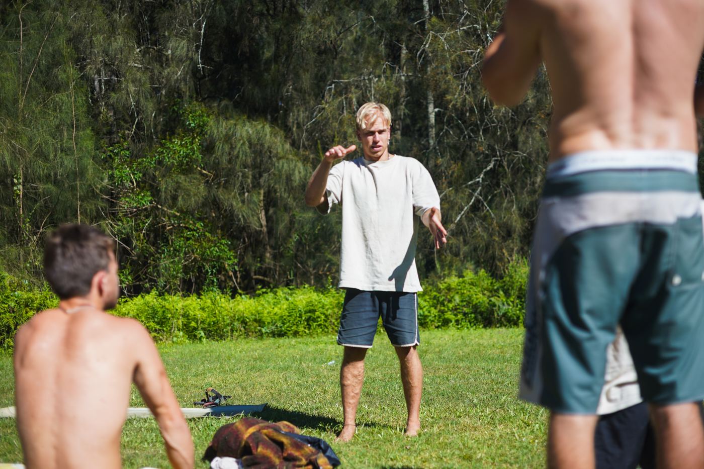 A man talking to the group on the grass