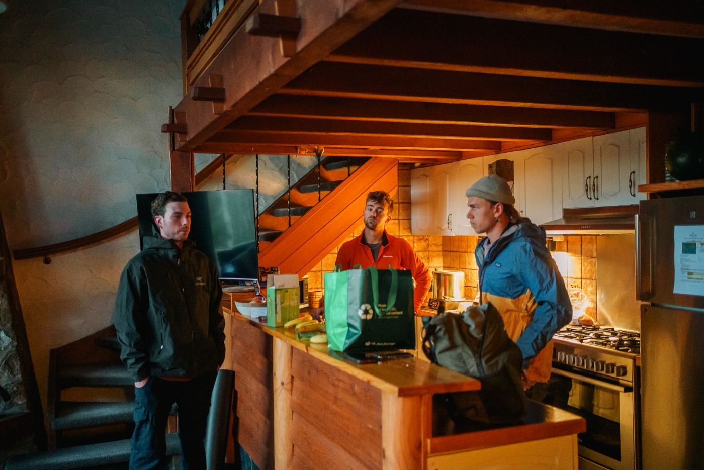 Men cooking together in a timber cottage kitchen