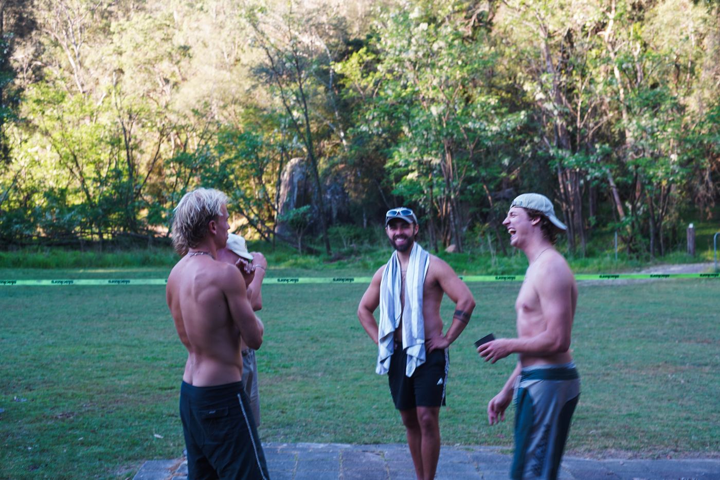Three men laughing on the grass